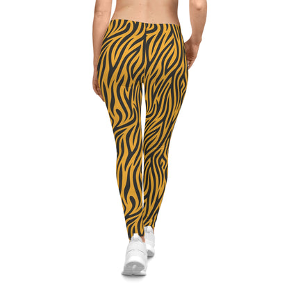 Rear view of casual leggings featuring a bold tiger stripe pattern with black wavy stripes on a vibrant orange background. The fabric has a smooth, silky texture.