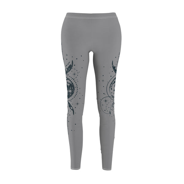 Front view of gray leggings featuring a vertical hand-drawn illustration of moon phases and geometric arrows on the left leg. The fabric has a soft, brushed suede texture with visible white stitching at the waist and hem.