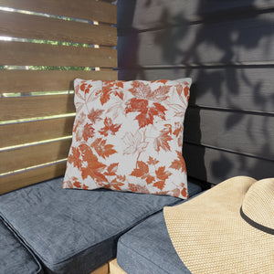 outdoor pillow with colorful autumn leaf print on patio chair