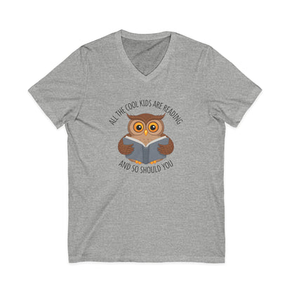 Gray v-neck t-shirt featuring a cartoon owl reading a book with the text All The Cool Kids Are Reading And So Should You.
