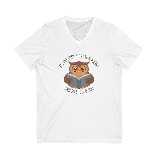 White v-neck t-shirt featuring a cartoon owl reading a book with the text All The Cool Kids Are Reading And So Should You.