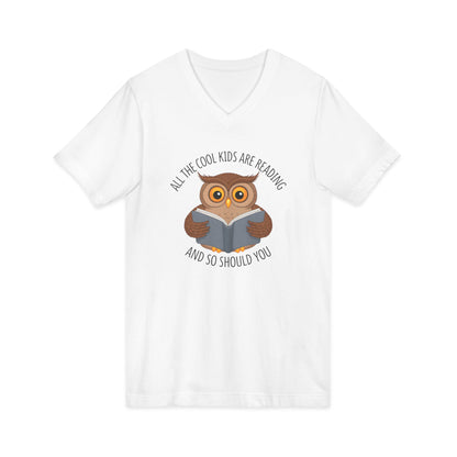 White v-neck t-shirt featuring a cartoon owl reading a book with the text All The Cool Kids Are Reading And So Should You.