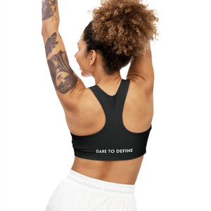 Back view of the Dare to Define sports bra in black, featuring a racerback design and the inspirational slogan 'Dare to Define' printed at the bottom.